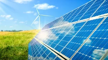 Solar panels and a wind turbine in sunny field