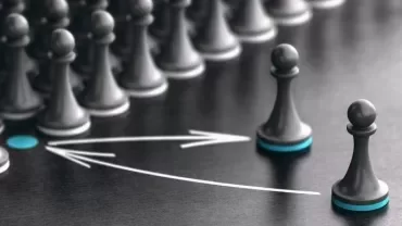 Two chess pawns with arrows on a board.