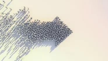 Aerial view of people forming an arrow shape on a white background.