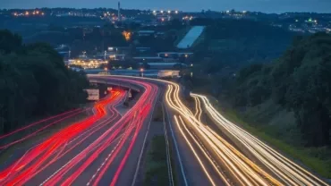 A highway at night with light trails from cars.