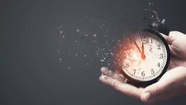 Alarm clock disintegrating in hands, symbolizing time fading.