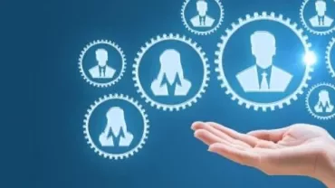 Illustration of gears with silhouettes over a hand.