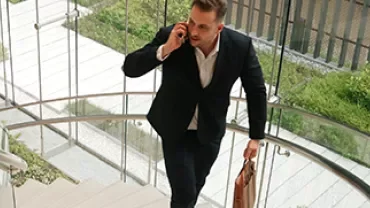 man walking while talking to phone