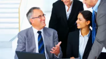 Business team discussing a project in an office setting.