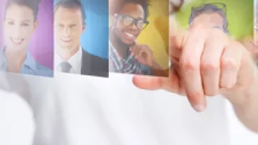 A person selecting one of several photos in a digital interface.