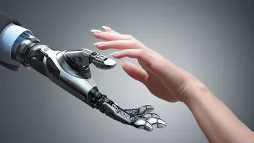 Une main humaine tendue vers une main robotique.