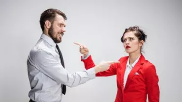 Man and woman pointing fingers at each other.
