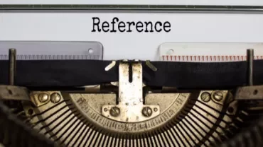 Close-up of a vintage typewriter with the word 'Reference' typed.