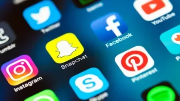 Close-up of social media app icons on a smartphone screen.