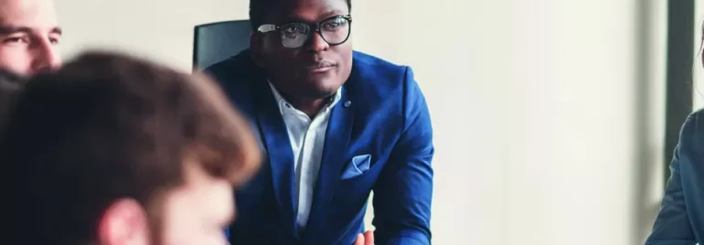 Business meeting with a focused man in a blue suit.
