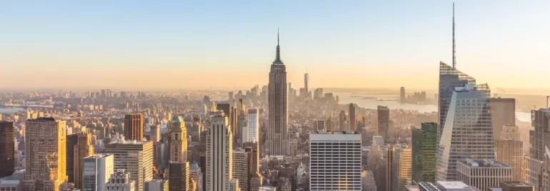 New York City skyline with the Empire State Building at sunrise.