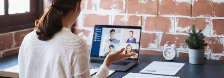 Woman engaging in a video conference call on a laptop.