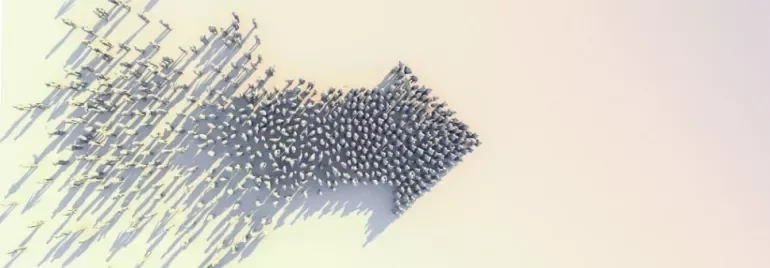 Aerial view of people forming an arrow shape on a white background.