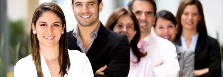 A group of smiling professionals standing in a line.