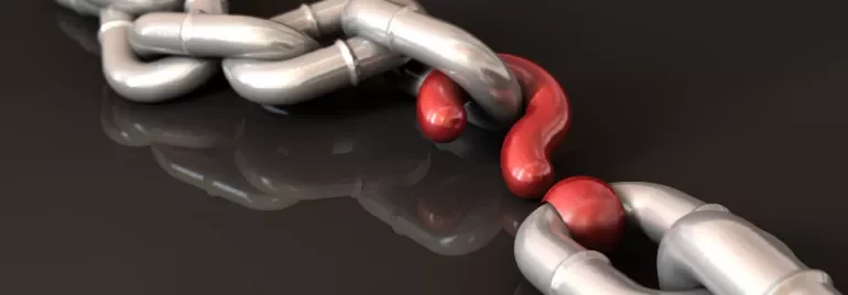 A metal chain with one red distorted link.