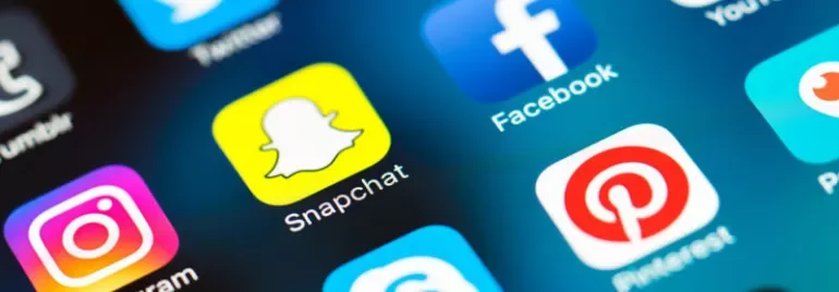 Close-up of social media app icons on a smartphone screen.