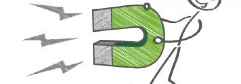 Stick figure holding a green horseshoe magnet with sparks.