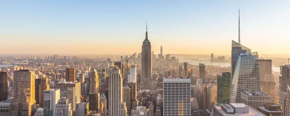 New York City skyline with the Empire State Building at sunrise.