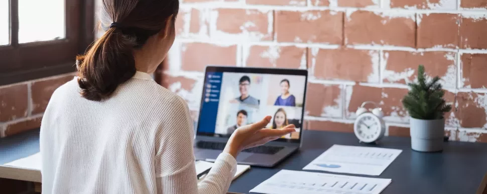 Woman engaging in a video conference call on a laptop.