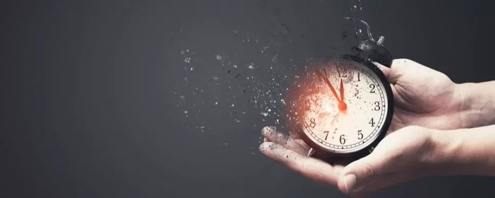 Alarm clock disintegrating in hands, symbolizing time fading.
